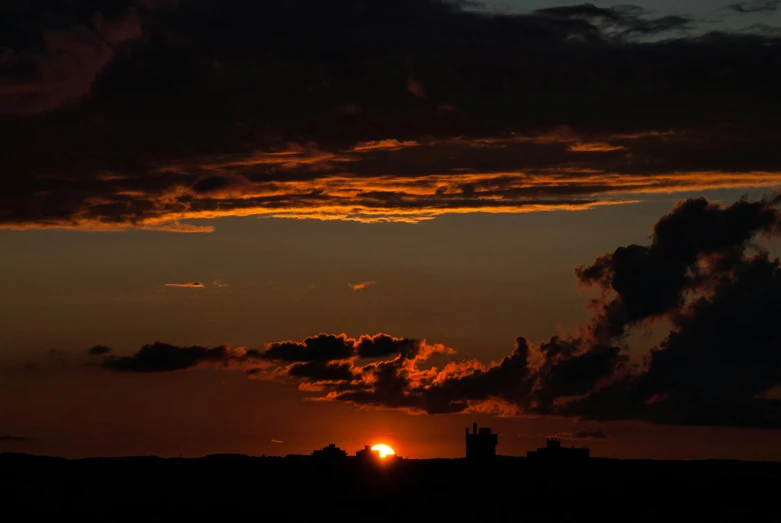 a jet flying across the sky at sunset