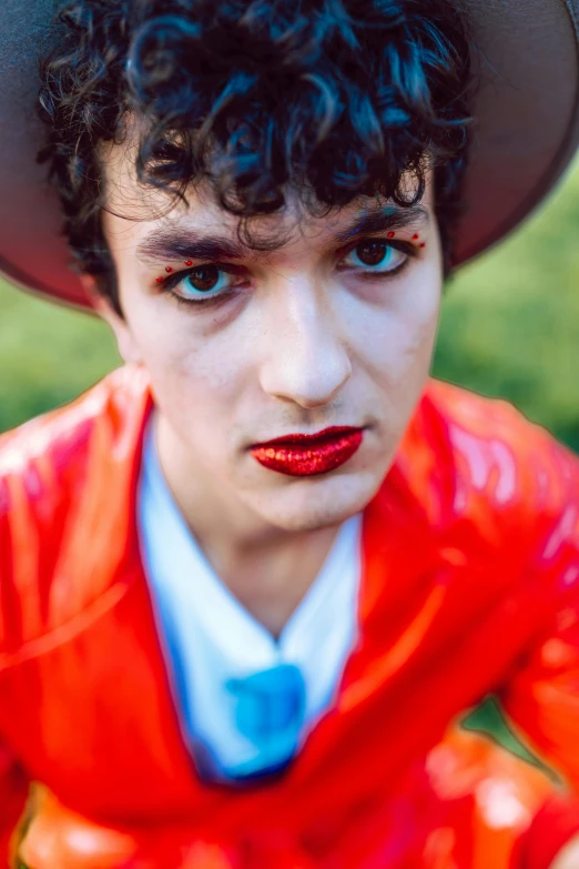 this man is dressed in a colorful outfit and hat