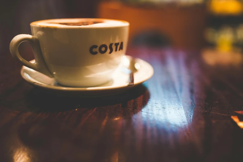 a coffee cup on top of a wooden table