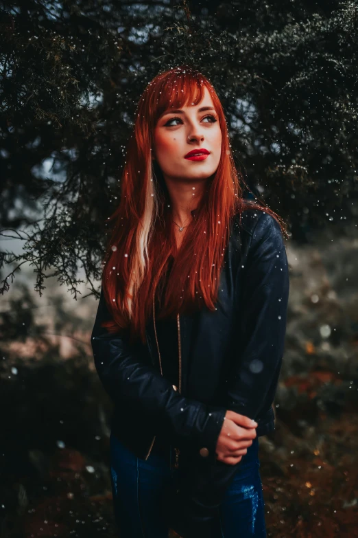 a woman with long red hair wearing black