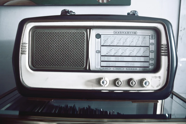 the old style radio is set on top of a shelf