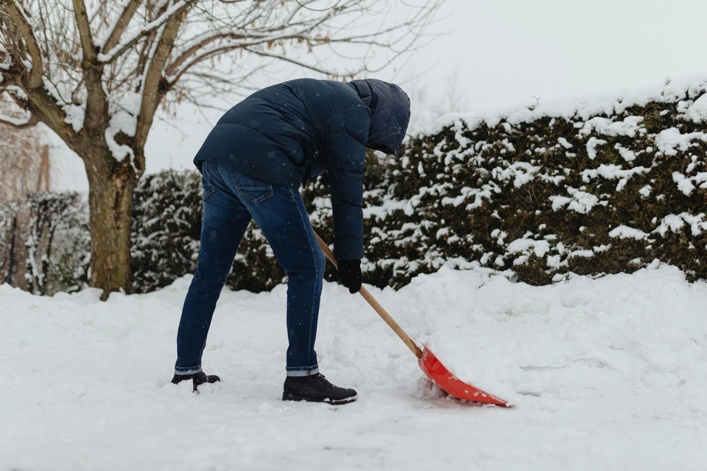 a person digging snow with a shovel