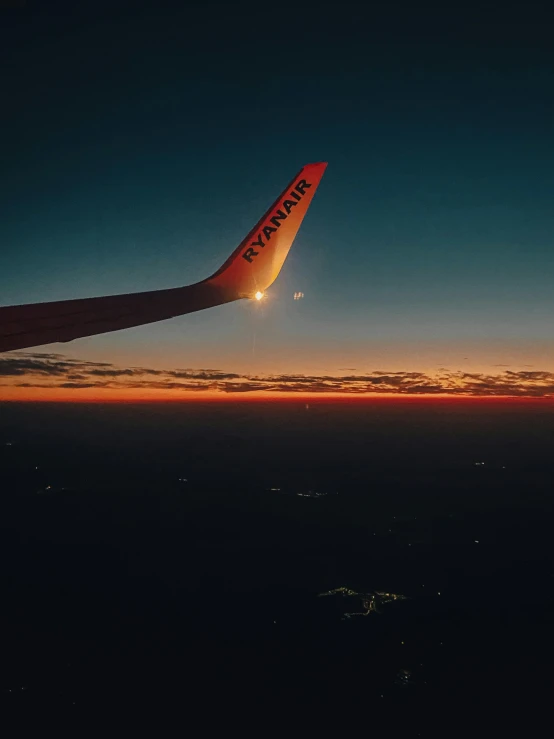 an airplane wing lit up by the sun