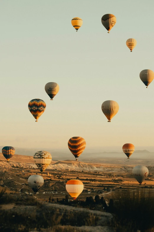  air balloons flying over an arid landscape