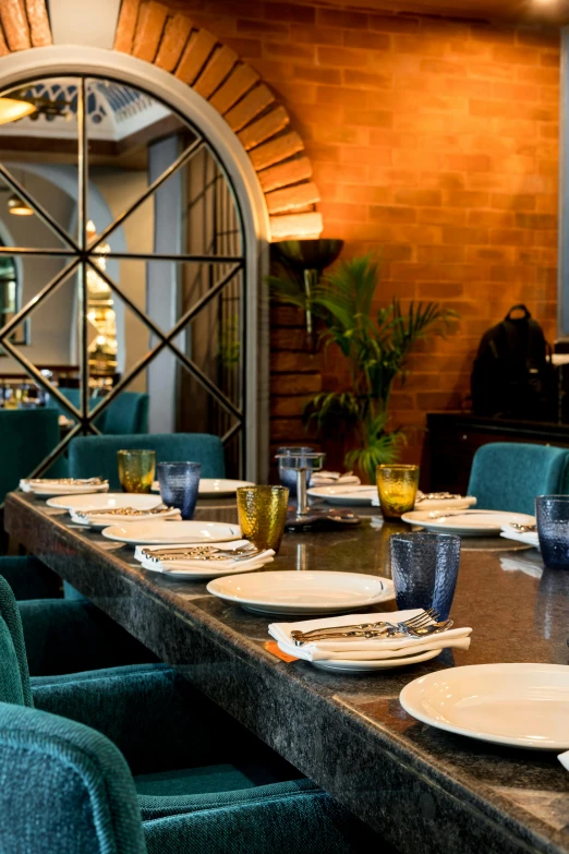 a table set for lunch with a mirror in the background