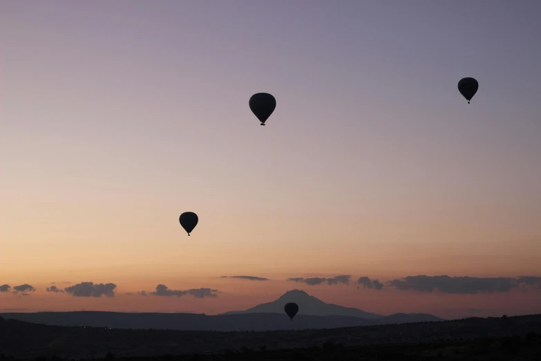 several  air balloons are flying high in the sky