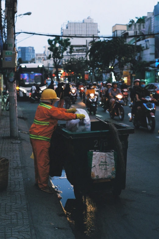 a man in orange and yellow outfit riding on a motorcycle