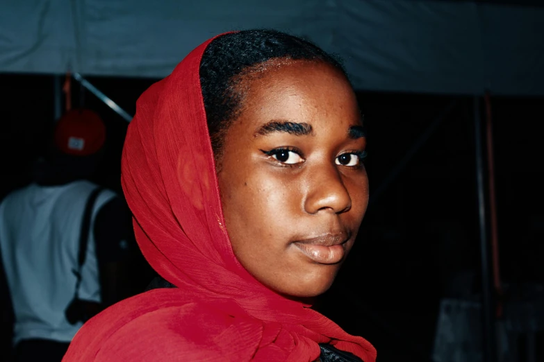 a girl with a red scarf around her neck