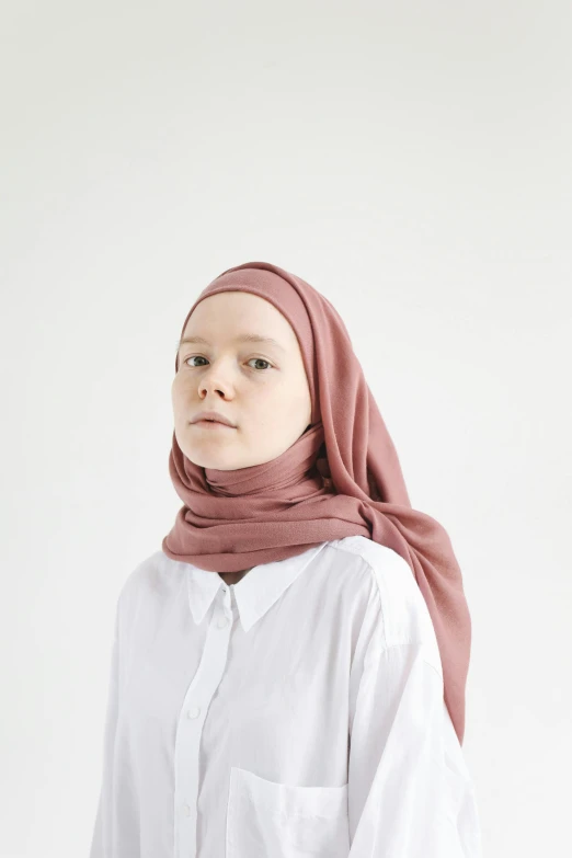 a girl in a white shirt and head scarf