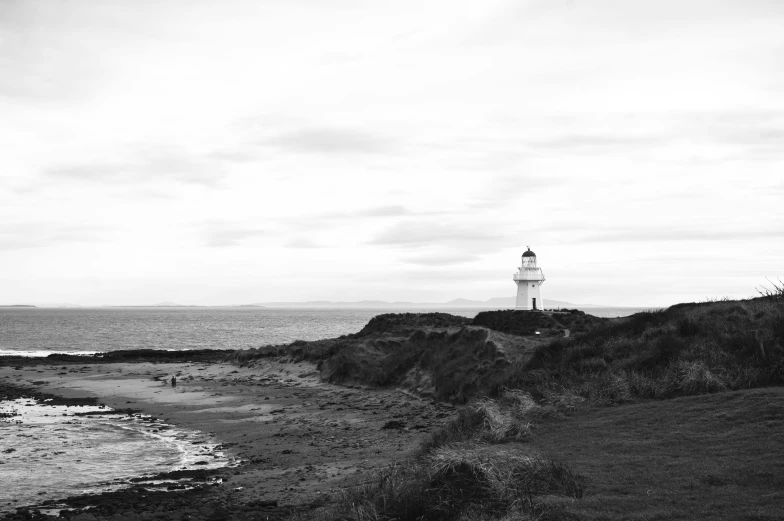 a black and white image of a lighthouse in the ocean