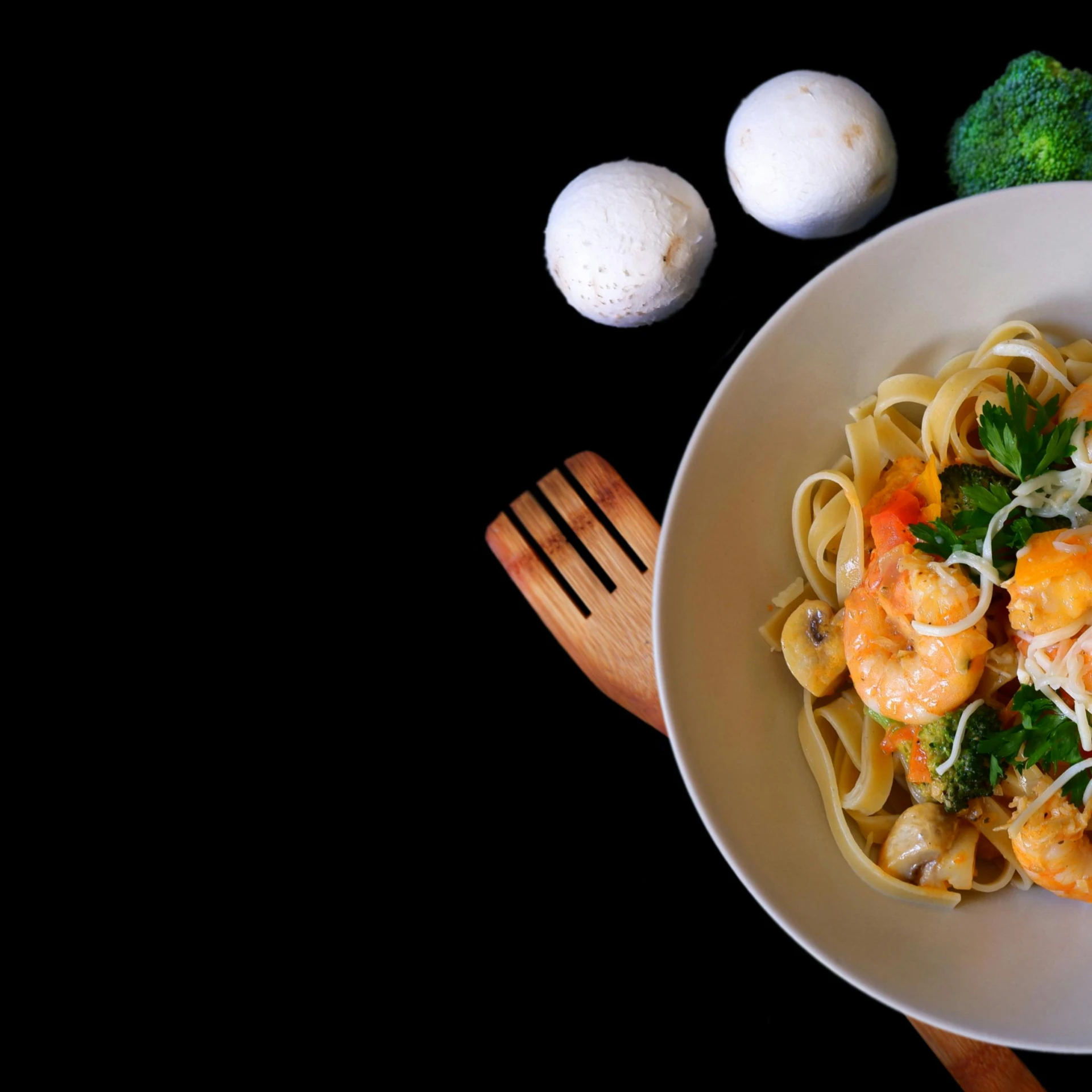 a white bowl with noodles, meat, and vegetables