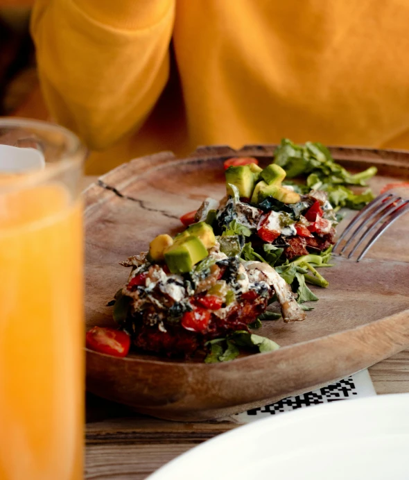 a person is eating a salad on a plate