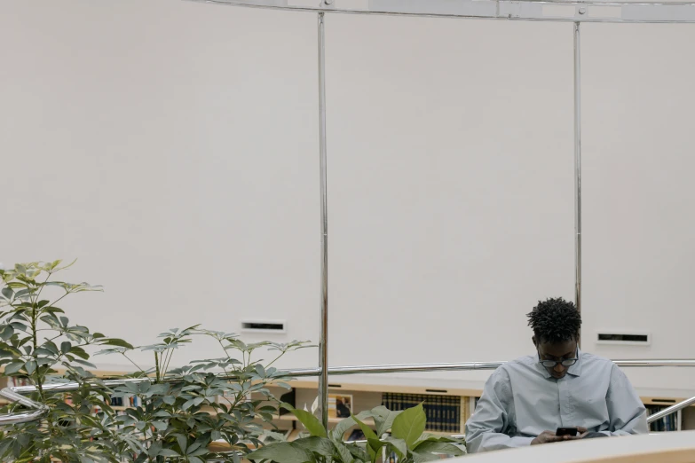 the man is sitting on a chair using his cell phone