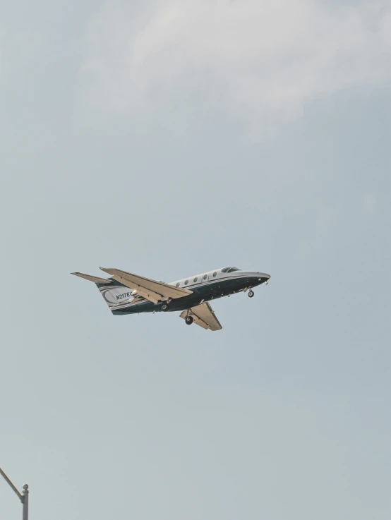 a plane flying with its landing gear down in the sky