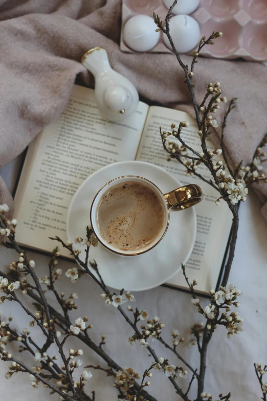 an open book with a spoon sitting on top of a table