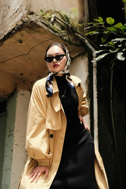 a woman poses for the camera in a dress and jacket