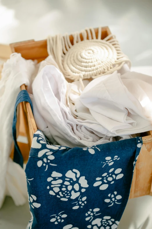 a blue and white bag containing clothing hanging on a rack