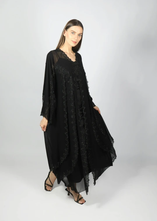 the black robe dress has a sheer back and white polka dots