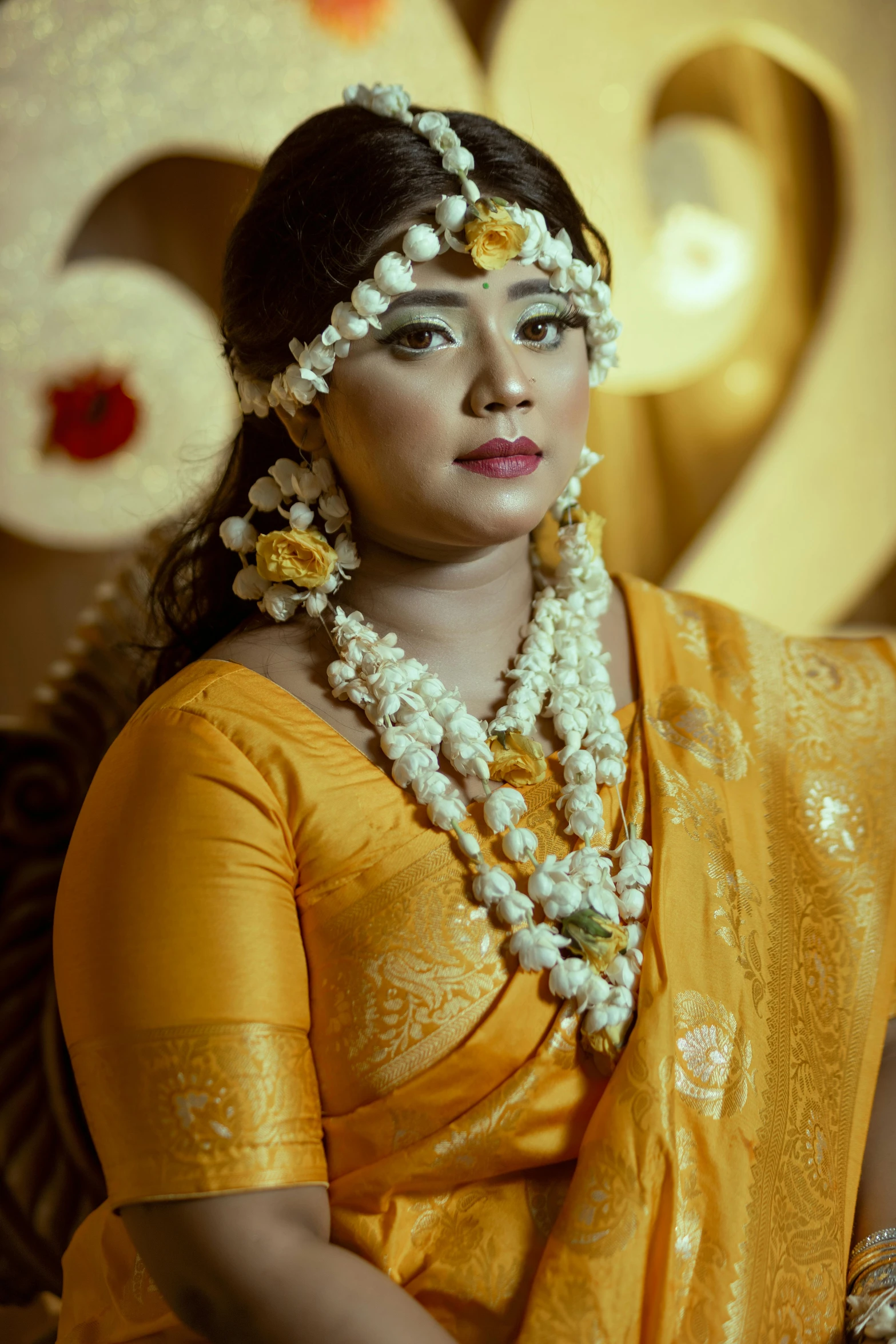 an indian woman in a yellow saree