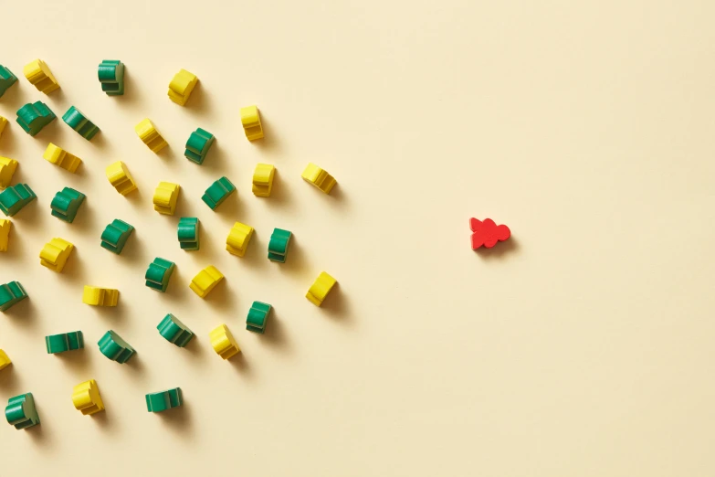 a number of lego blocks and pieces of the same item on a light surface