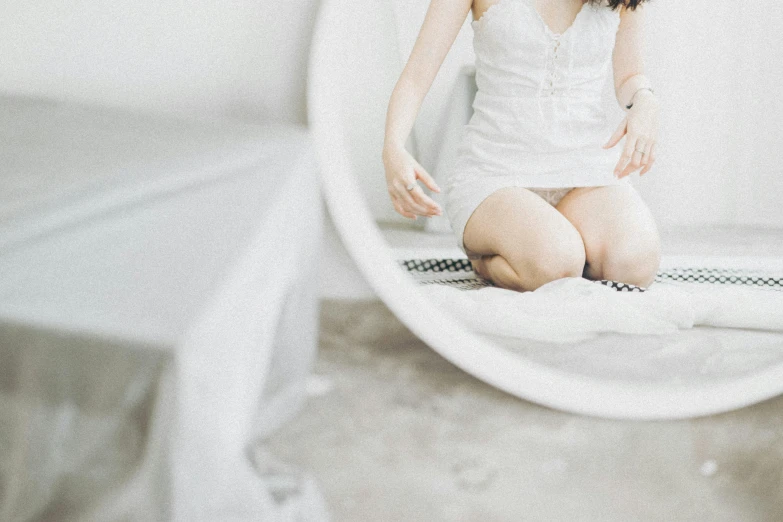 a woman sits on a bed in a mirror