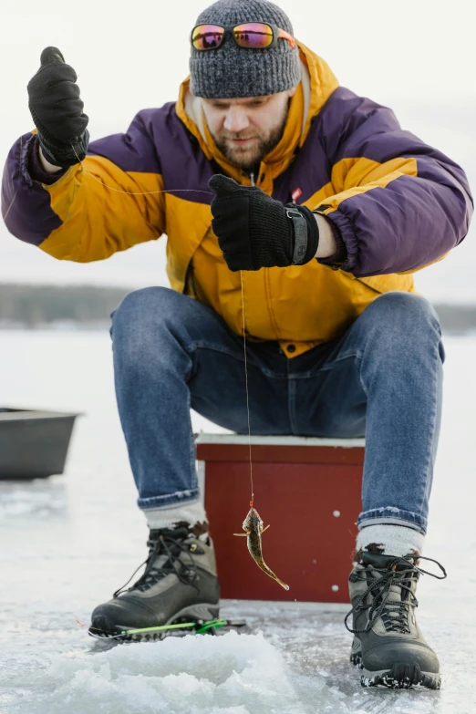 a man sitting on top of an ice box