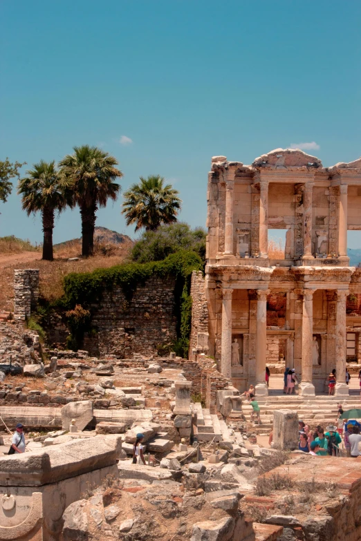 people standing in ruins of a roman city