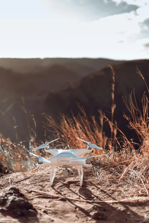 a white remote controlled flying object sitting in the sun