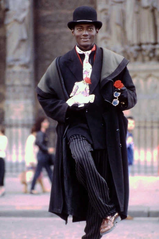 man dressed up in traditional clothing walking down the street