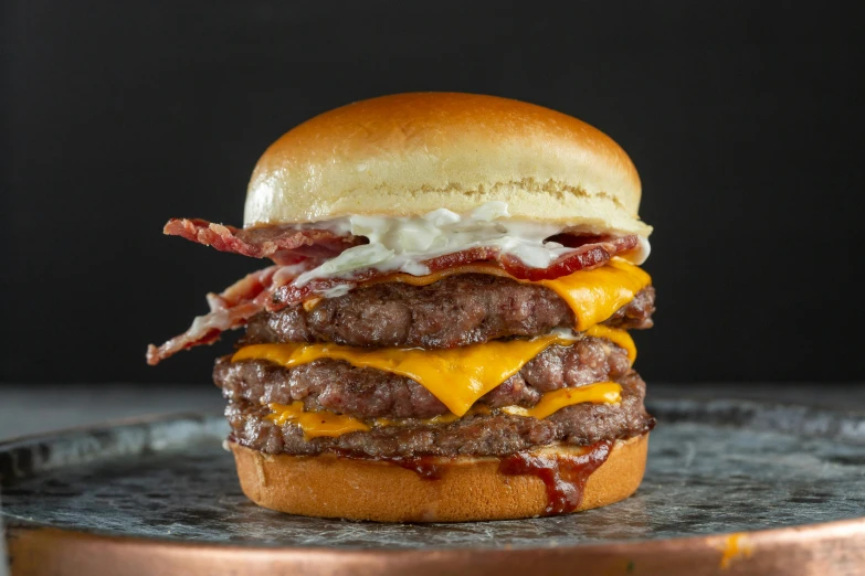 a burger is on top of a metal tray