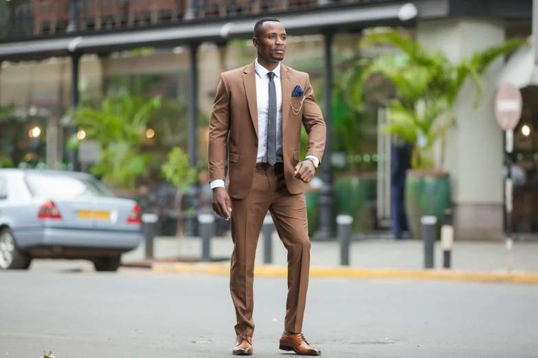 a man in a brown suit and white shirt