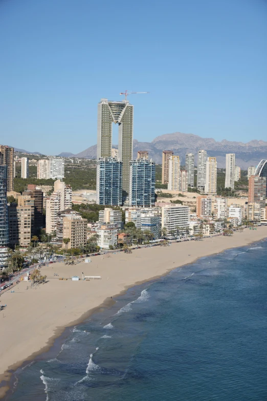 a beach in front of some very tall buildings