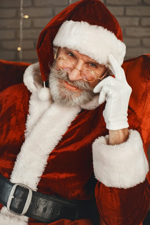 man in santa suit sitting and talking on cell phone