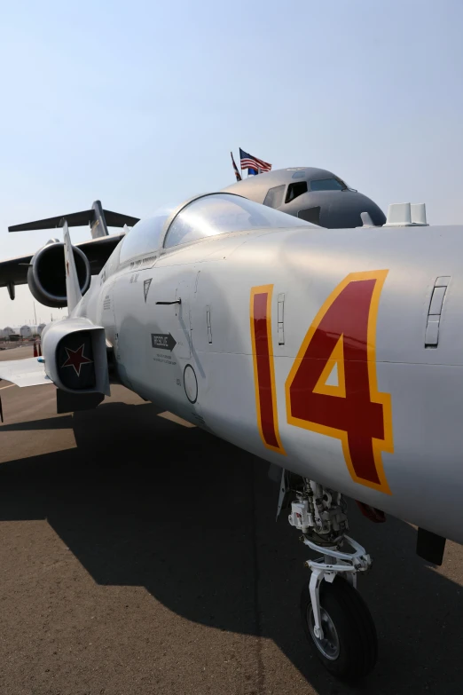 the nose of a military aircraft parked on a runway