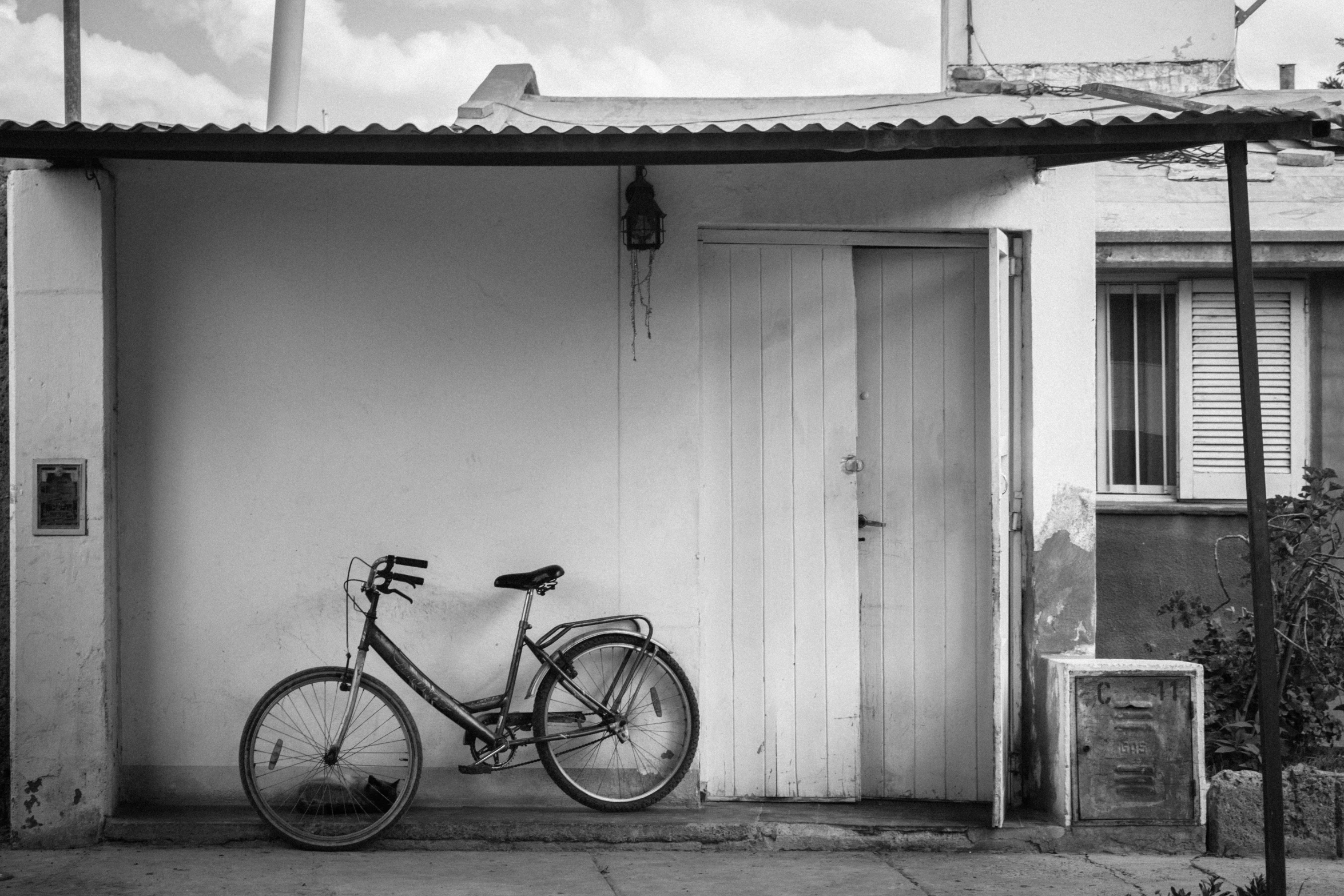 a bicycle that is sitting up against a house