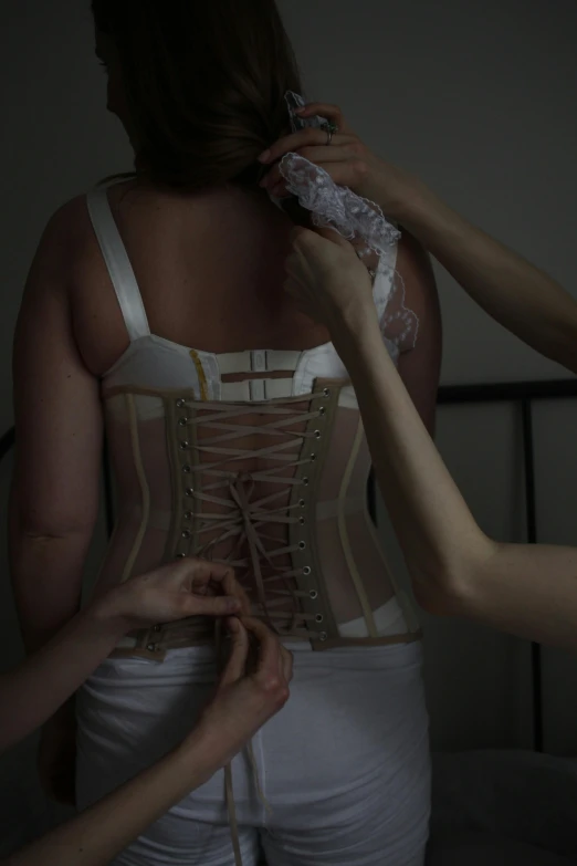 the back of a woman's corset being made