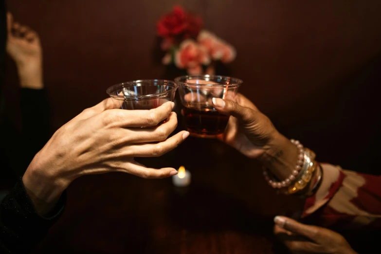 a group of people raising their hands in to a toast