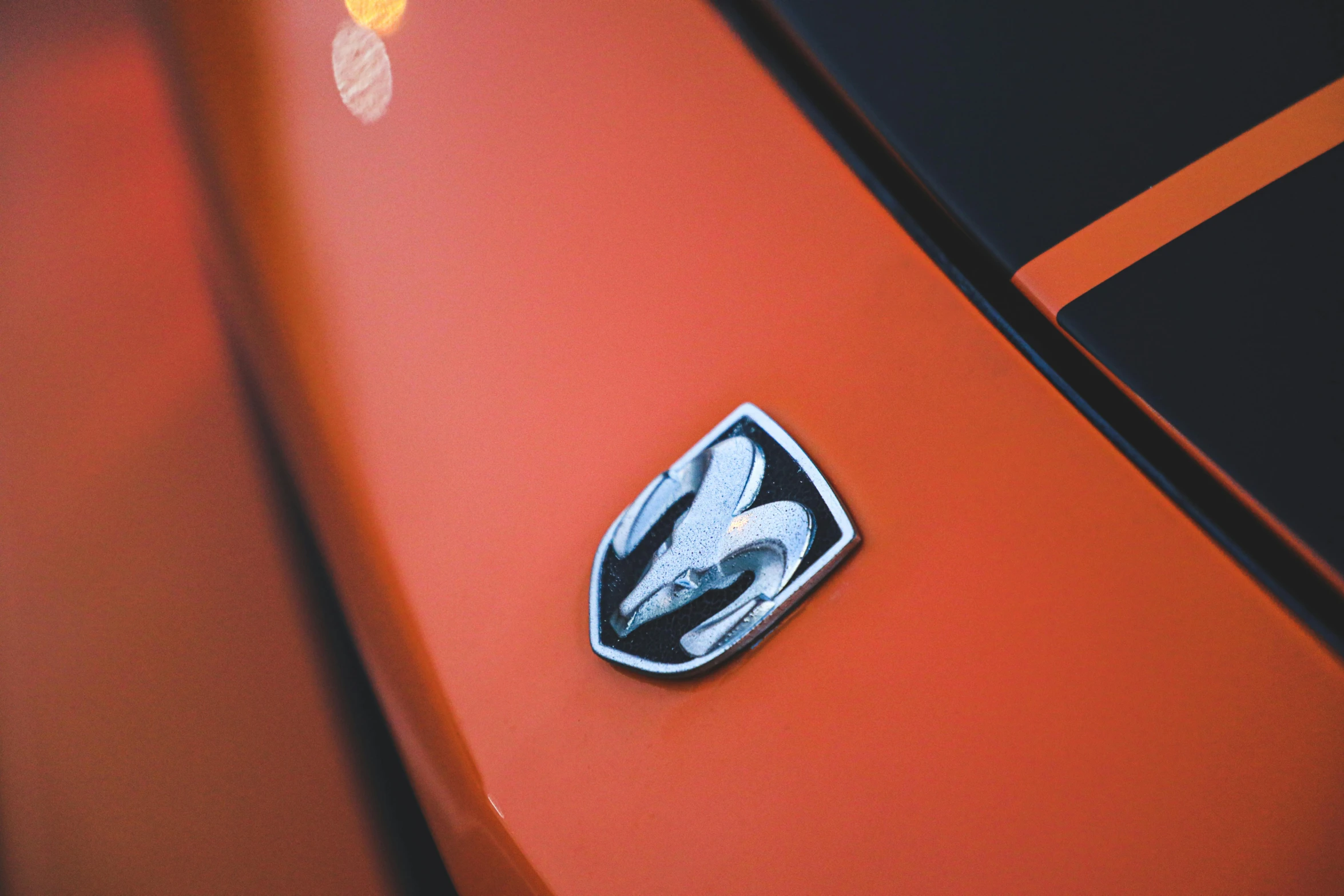 the emblem on a car is painted bright orange