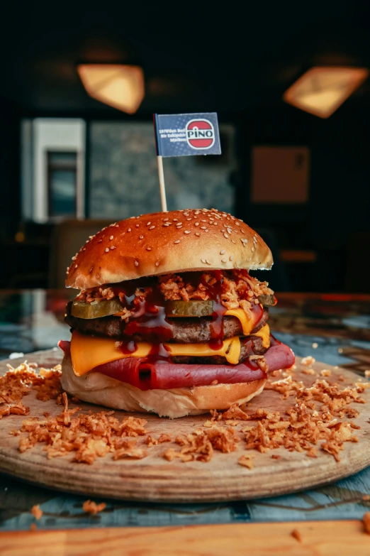 a large cheeseburger is sitting on a wooden platter