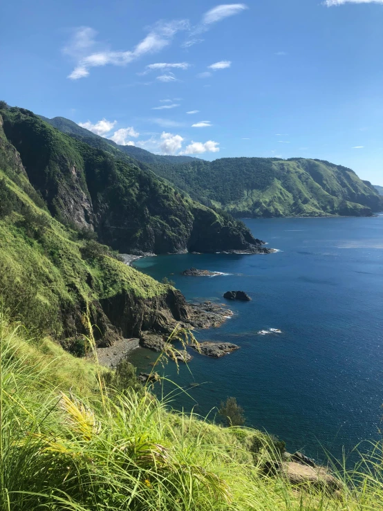 two mountains overlooking water, and green hillside on one