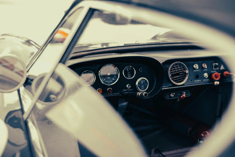 a steering wheel inside of a car with a big dash light