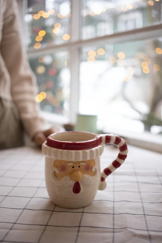 a mug is decorated with a sock and a reindeer