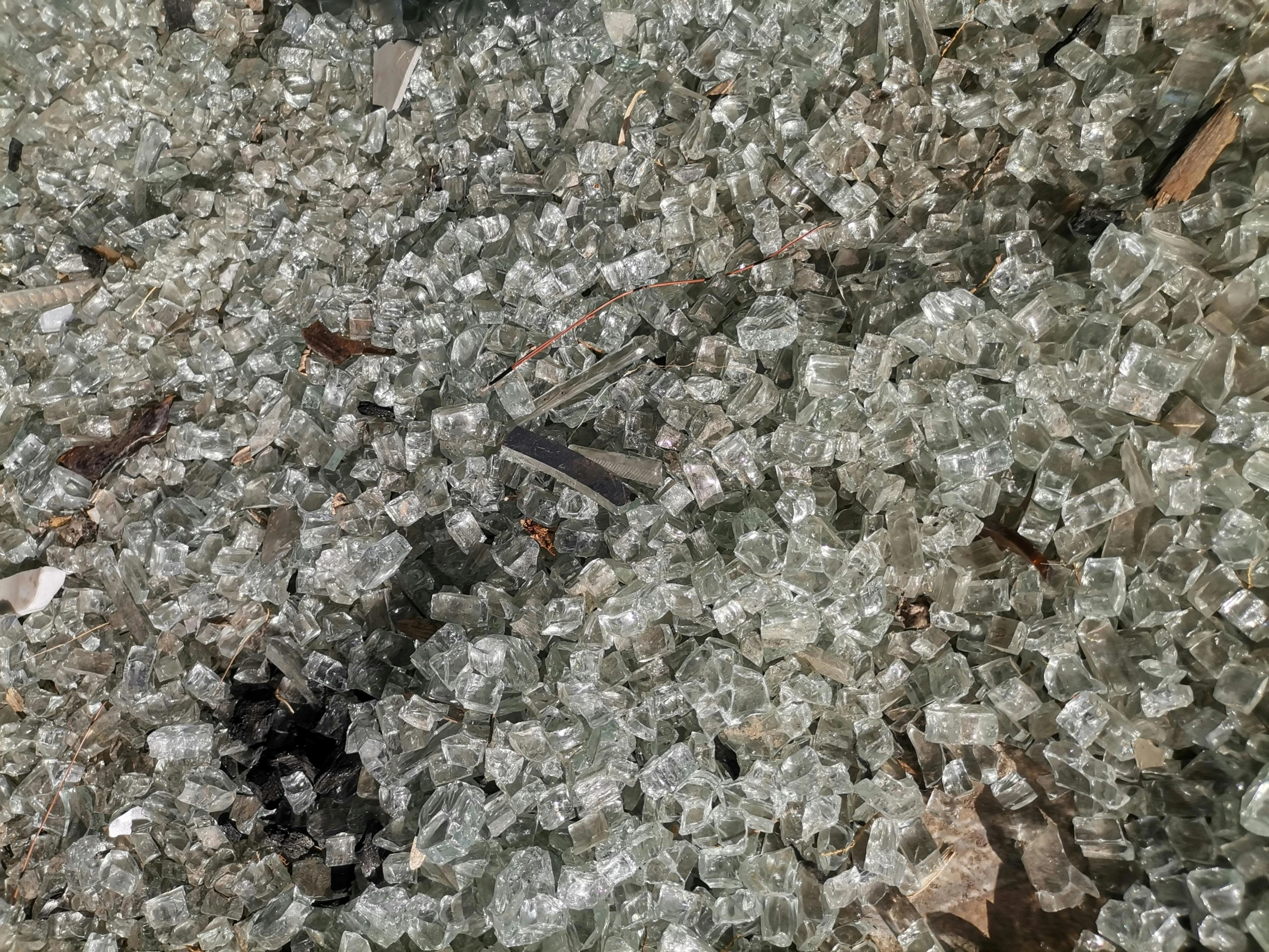 a view looking down at a cluster of broken glass shards