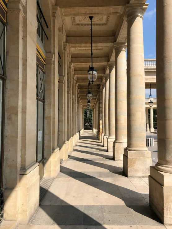 an old building with pillars lined up with light