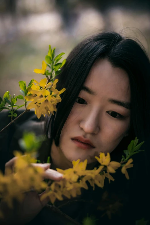 a person who is looking down at the flowers