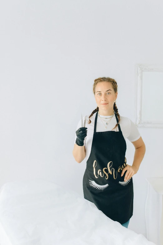 a woman in black apron with a white background