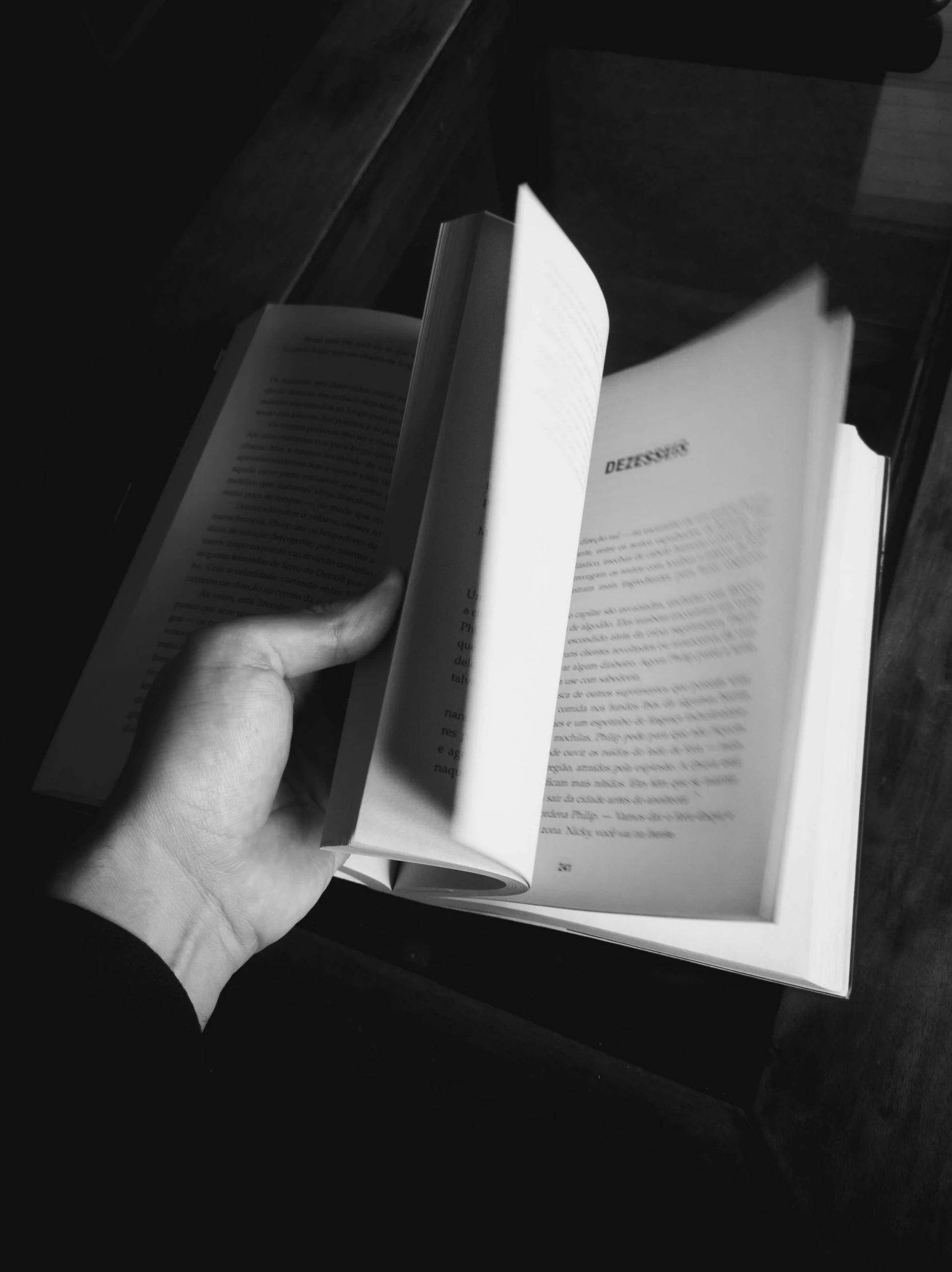 a person is holding up an open book