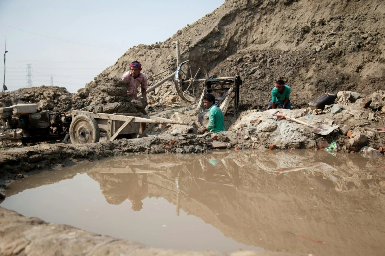 two women work at construction site in muddy area