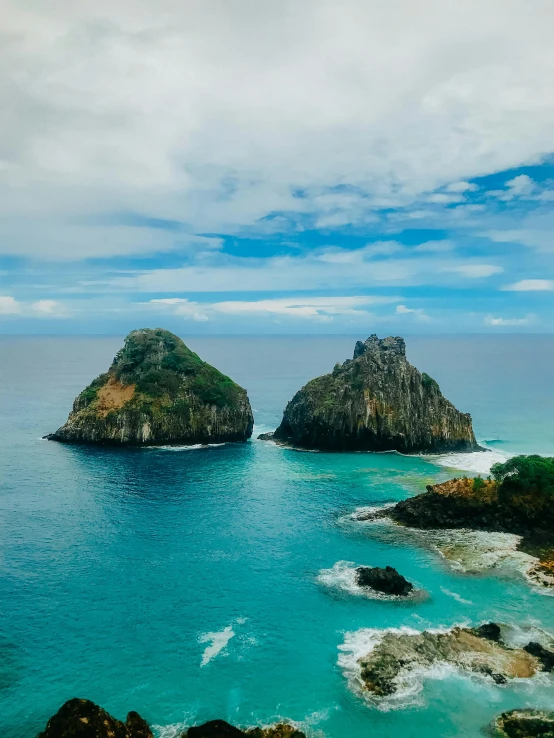 a beautiful landscape of two very large rocks with some water in the background