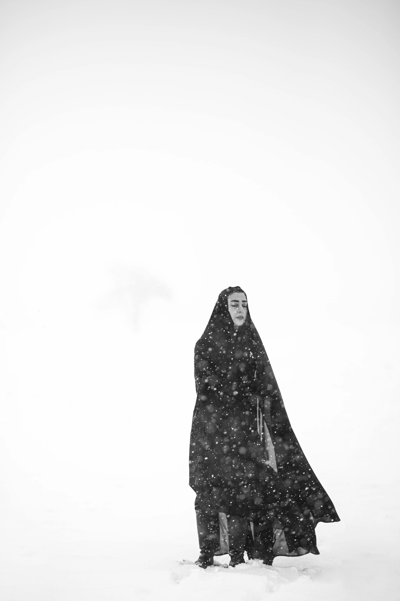 a woman with a black and white cloak and a frizbee on